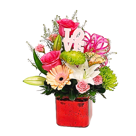 A pretty cube floral design with pink roses, gerberas, spray roses and green fugi mums.