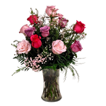 Beautiful vase arrangement of a dozen coloured roses in pinks and lavenders.