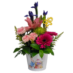 Pretty blooms of pinks, purple and greens are nestled in our keepsake Peter Cottontail pot. A delight to give and receive!