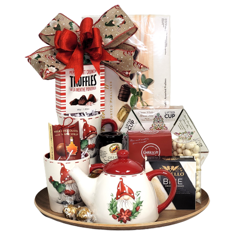 This gnome teapot with two matching mugs will make it feel good to be home for the Holidays. Along with the festive keepsakes, they'll enjoy chocolates, cookies, tea, crackers, cheese and more all nicely arranged on a serving tray. (Tray designs may vary).