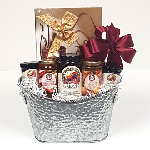 A designer silver gourmet gift basket tin filled with a variety of Greaves Jams from Niagara on the Lake together with lovely Cider Keg sparkling jellies, and a lovely box of European chocolates.