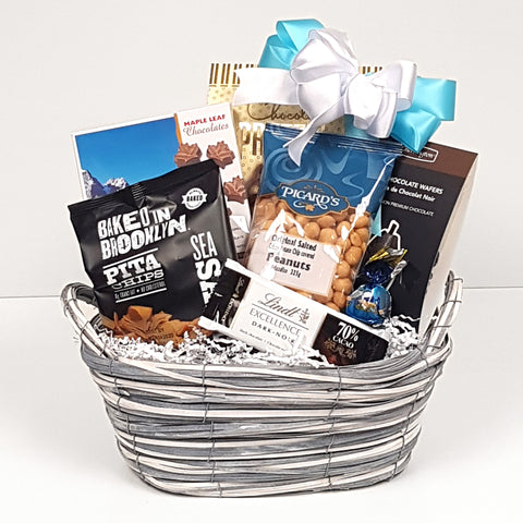 A sweet & salty gift basket containing nuts, chocolate, pretzels and pita chips to enjoy.