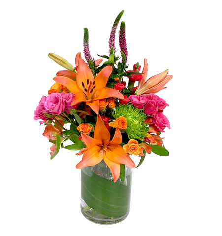 Bright & spicy floral arrangement in hues of orange, fuschia and greens with lilies, fugi mums, alstromeria and more.
