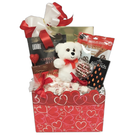 Carefully arranged among the delicious delicacies is a charming Valentine's Day teddy bear accompanied by gourmet popcorn, cookies, pretzels coated in chocolate, delectable truffles, assorted nuts and more.