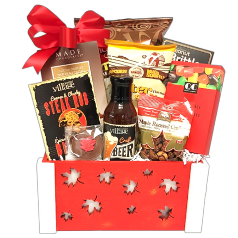 Wooden maple leaf crate filled with Canadian gourmet treats. There's BBQ sauce, seasonings, nuts, chocolate, brittle, popcorn and jujubes too.