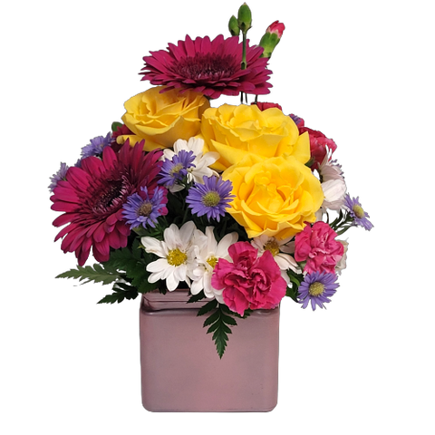 Send your thanks with this pretty cube vase arrangement of gerberas, daisies, roses and more in bright and sunny hues sure to brighten the day! 