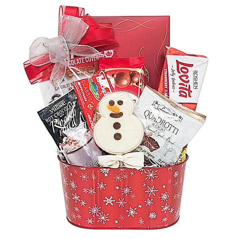 Red holiday tin with white snowflake design filled with a chocolate lover's dream. There's chocolate pretzels, chocolate wafers and cookies, hot chocolate, truffles and a chocolate lolly too!