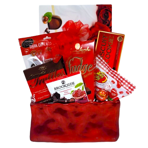 A sweet gift basket to say "I'm Yours"! Filled with all sorts of sweet treats to enjoy. There's chocolate covered pretzels, truffles, jelly beans, fudge and biscuits too!