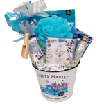 Gift basket with bath salts, sachets, biscuits, treats and a journal.