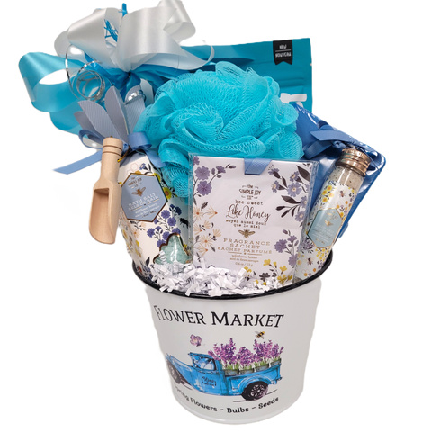 Gift basket with bath salts, sachets, biscuits, treats and a journal.