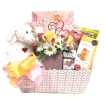 Send a loving touch with this pretty pastel basket filled with sweet treats to enjoy along with a pretty floral cube arrangement and a cute plush animal to cuddle.