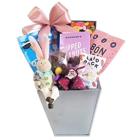 Some bunny will delight in this Easter gift basket of treats. There's jelly beans, dipped peanuts, gummy treats, nuts, chocolate covered pretzels and more along with a cute bunny ornament to keep.
