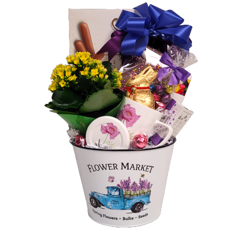 A pretty "Flower Market" tin is brimming with a flowering plant, pretty mug with keep warm lid, tea, chocolate bunny, jelly beans and more yummy treats!  