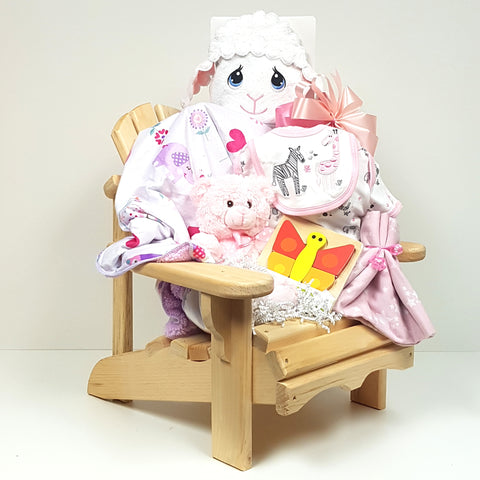 A baby gift basket consisting of a beautifully crafted muskoka chair filled with a plush blanket, Precious Moments hooded towel, onesie, bib and more.