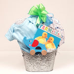 A pretty silver tin baby gift basket containing a onesie, receiving blanket, baby board book and a classic pull toy.