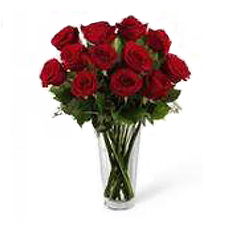 A dozen premium red roses beautifully arranged in a clear glass vase