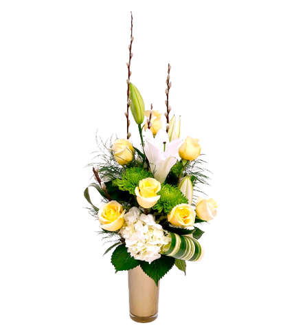 Beautiful floral vase arrangement with cream coloured roses, white hydrangea and lilies.