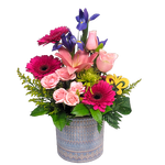 As pretty as a picture, this beautiful arrangement of pretty pinks, purples and greens is nestled in a lovely ceramic pot.  