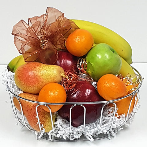 A comforting fruit assortment carefully nestled in a beautiful stainless steel fruit gift basket.