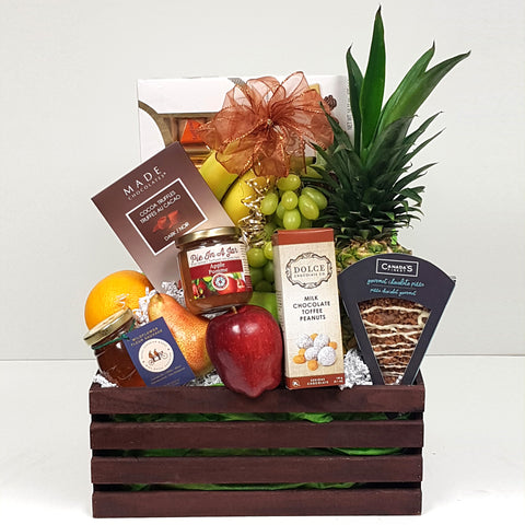 A beautiful selection of fresh fruit, specialty treats, honey, chocolates and more creatively arranged in a handy wooden crate fruit gift basket.