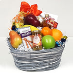 A pretty fruit gift basket brimming with delicious chocolate, maple syrup, sparkling jelly, fruit, cookies and sparkling water too!