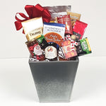 A lovely tall tin gift basket brimming with coffee and tea, a yummy pancake mix with maple syrup, some jams and jellies, cookies and truffles.