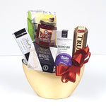 A pretty half moon gold container gift basket filled with cheese, crackers, red pepper jelly, savoury shortbread, truffles and chocolate too.