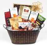 A gourmet gift basket consisting of coffee, spiced apple cider and tea along with some biscuits, chocolates, crackers and lovely Cider Keg sparkling jelly nestled in a pretty basket weave tin.