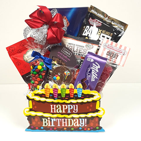 A specialty birthday cake gift basket that's overflowing with sweet & salty snacks of all kinds.