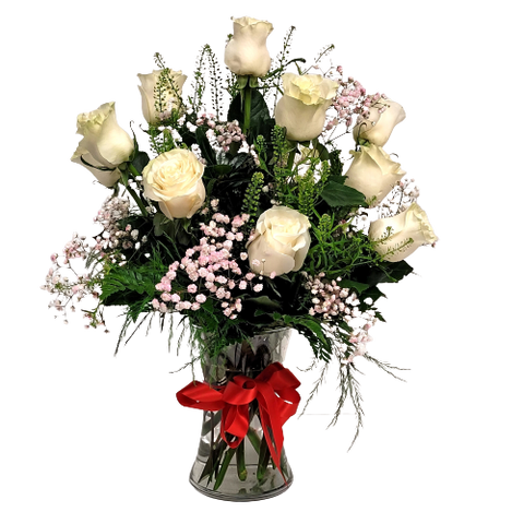 Vase of dozen white roses with greens and baby's breath.