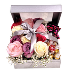 Silver sparkly box with dozen coloured roses of pinks, lavender and white with truffles nestled inside.