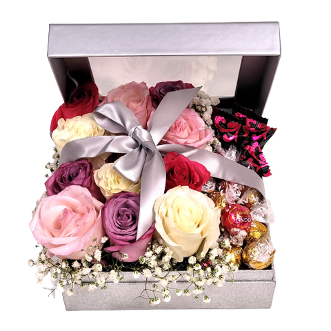 Silver sparkly box with dozen coloured roses of pinks, lavender and white with truffles nestled inside.