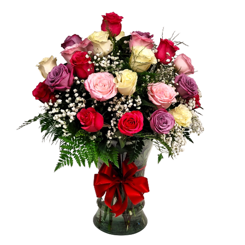 Large clear glass vase filled with 2 dozen coloured roses in pinks, lavender and white.