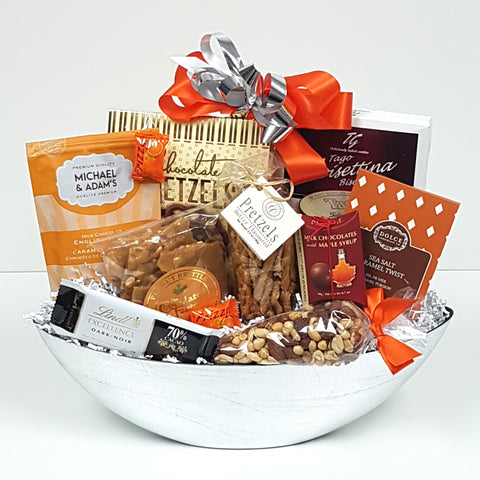 A sweet & salty gift basket filled up with peanut brittle, pretzels, nuts, chocolates, caramel twists and more.