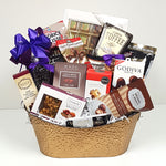 A sweet & salty gift basket containing European chocolates, toffees, salty bar mix, Godiva chocolates, cookie dough bites, brittle, licorice and many other delightful treats.