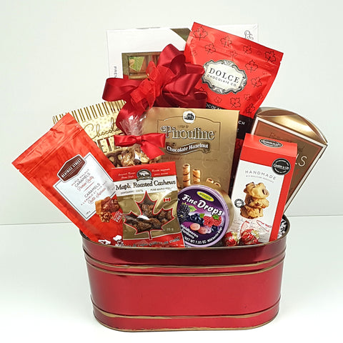 A sweet & salty gift basket holding handmade shortbread, maple roasted cashews, fine candy drops, delectable chocolate, pretzels and some maple caramel crunch.