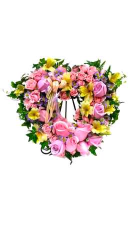 Open heart floral design of soft hues of pinks, yellows and lavender in roses, spray roses, alstromerias and asters.