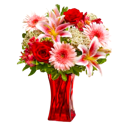 Tall red glass vase filled with red roses, pink gerberas, alstromeria, lilies, rice flowers and greens.