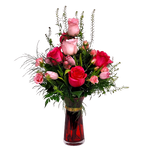 A lush vase arrangement of soft coloured roses and tulips beautifully designed in a pretty vase.